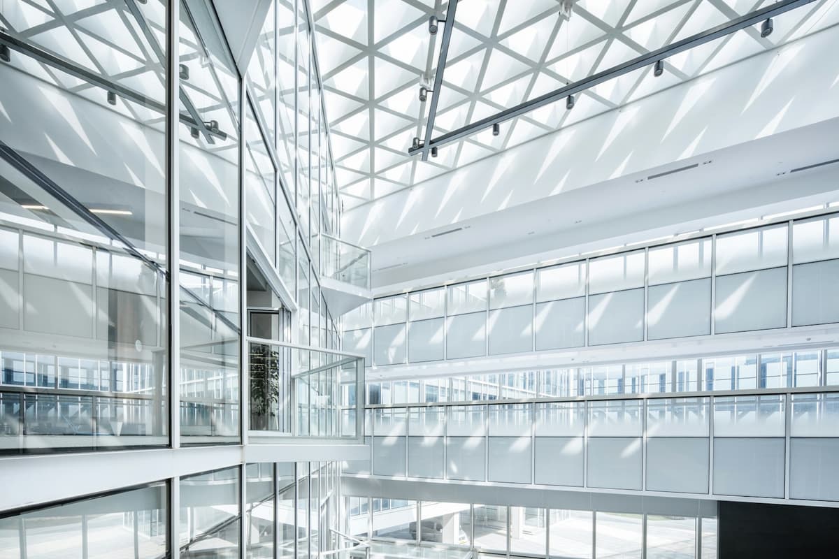 Light-filled office atrium with glass walls and open walkways